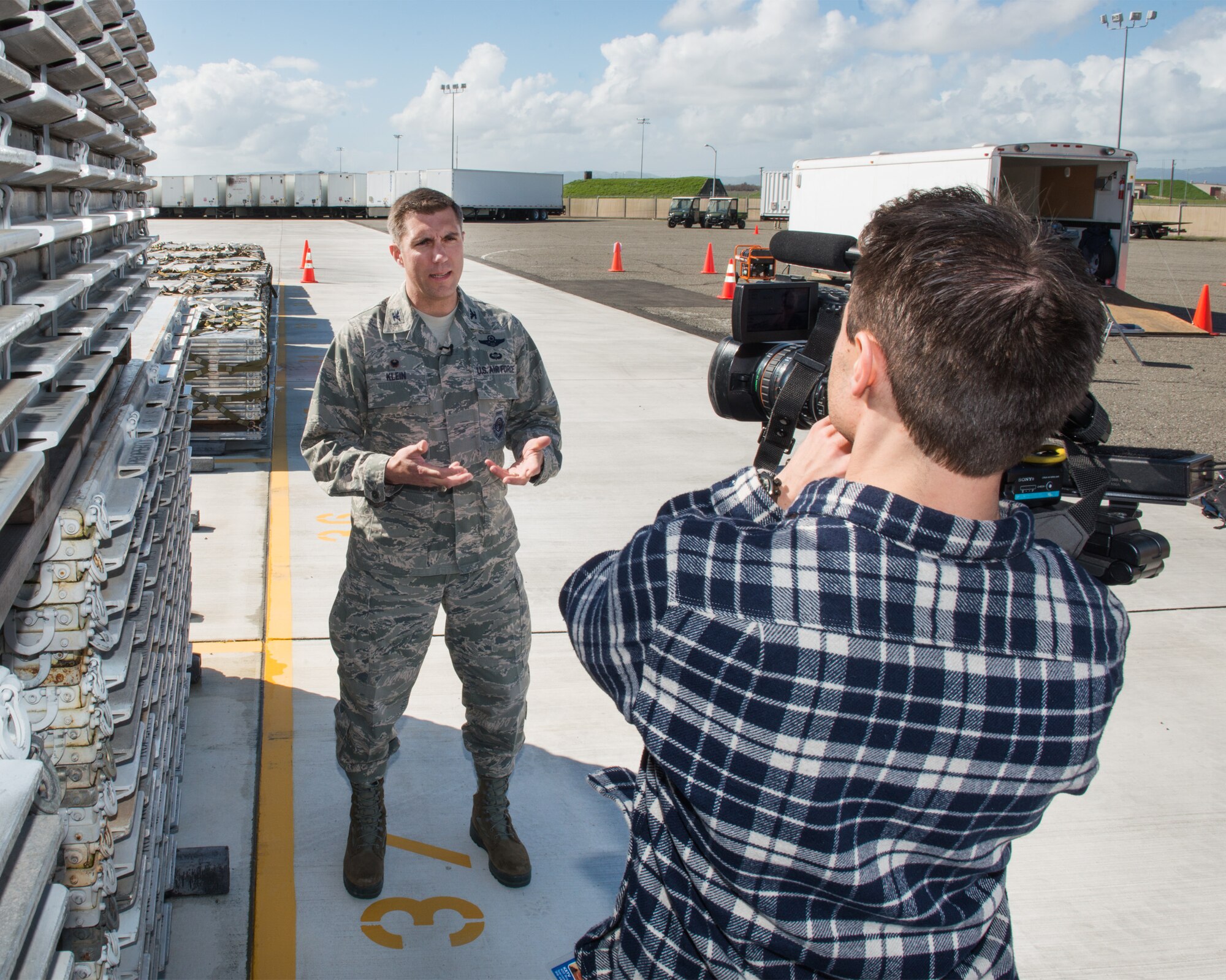 U.S. Air Force Col. John Klein, 60th Air Mobility Wing commander, conducts an interview with local media at Travis Air Force Base, Calif., Feb. 16, 2017. Travis AFB is acting as a staging area for FEMA personnel, providing space for necessary equipment and supplies in case of the Oroville auxiliary spillway failure. (U.S. Air Force photo/Louis Briscese)
