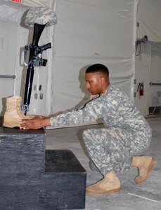 Spc. Karahn Yates, a U.S. Army Reserve Soldier with Army Reserve Medical Command’s 7227th Medical Support Unit, pays tribute to a fallen Soldier during a mock memorial ceremony held as a training opportunity in preparation for the unit’s upcoming mobilization in support of Landstuhl Regional Medical Center’s Deployed Warrior Medical Management Center.  Soldiers assigned to the 7227th MSU, out of Columbia, Missouri, have been working alongside 1st Army Division West’s observer coach/trainers with 4th Battalion (Medical), 393rd Infantry Regiment in North Fort Hood for three weeks in preparation for their upcoming mission.