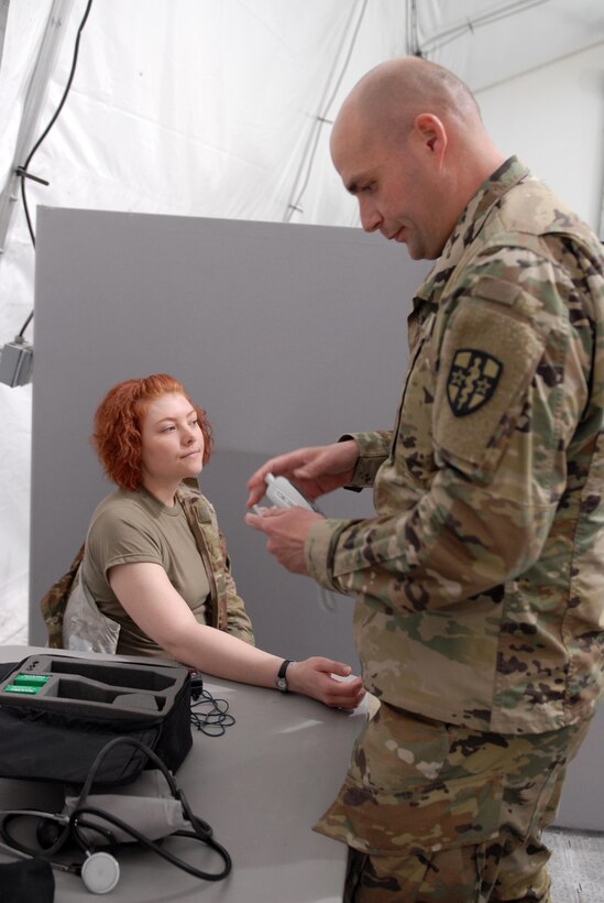 Sgt. Brittany Shafer, a U.S. Army Reserve Soldier with Army Reserve Medical Command’s 7227th Medical Support Unit, discusses a series of symptoms at the sick call clinic as a mock patient testing the responses of practical nursing specialist, Sgt. Donald Schneider.  The scenarios placed on Soldiers within the 7227th are training and validation injects in preparation for the unit’s upcoming mobilization in support of Landstuhl Regional Medical Center’s Deployed Warrior Medical Management Center.  Soldiers assigned to the 7227th MSU, out of Columbia, Missouri, have been working alongside 1st Army Division West’s observer coach/trainers with 4th Battalion (Medical), 393rd Infantry Regiment in North Fort Hood for three weeks in preparation for their upcoming mission.