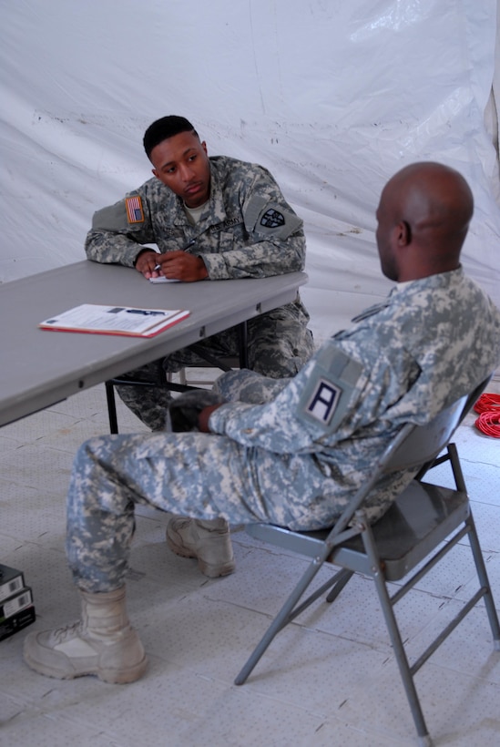 Spc. Karahn Yates, a U.S. Army Reserve Soldier with Army Reserve Medical Command’s 7227th Medical Support Unit, discusses a series of symptoms with a Soldier who is participating in a training scenario to test Yates’ responses as a behavioral health specialist during patient inprocessing.  The scenarios placed on Soldiers within the 7227th are training and validation injects in preparation for the unit’s upcoming mobilization in support of Landstuhl Regional Medical Center’s Deployed Warrior Medical Management Center.  Soldiers assigned to the 7227th MSU, out of Columbia, Missouri, have been working alongside 1st Army Division West’s observer coach/trainers with 4th Battalion (Medical), 393rd Infantry Regiment in North Fort Hood for three weeks in preparation for their upcoming mission.