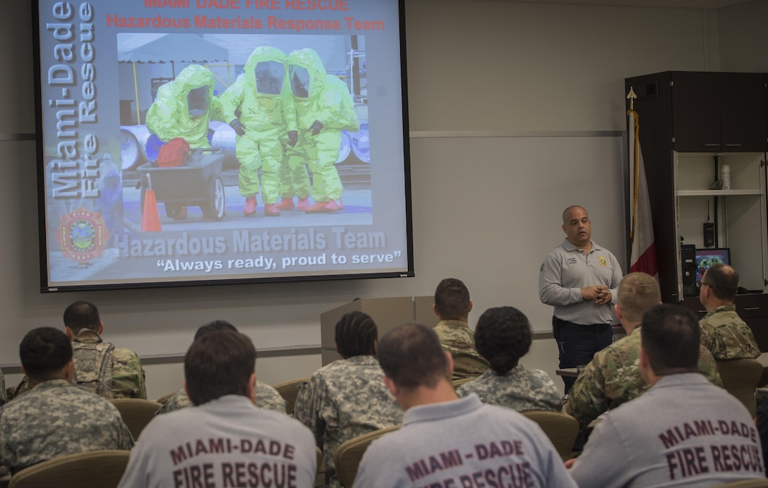 Lt. Al Tonanez, Miami-Dade Fire Rescue training officer, speaks to soldiers from the 329th Chemical Company and the 469th Medical Company prior to hazardous material training on Miami-Dade Fire Rescue headquarters, Miami, Fl. Feb 17, 2016. These training events were held by fire rescue personnel in preparation for a validation exercise held by U.S. Army North and U.S. Northern Command. 