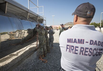 Lt. Al Tonanez, Miami-Dade Fire Rescue fire rescue training officer, observes soldiers from the 329th Chemical Company secure hazardous material during training on Miami-Dade Fire Rescue headquarters, Miami, Fl. Feb 17, 2016. These training events were held by fire rescue personnel in preparation for a validation exercise held by U.S. Army North and U.S. Northern Command. 