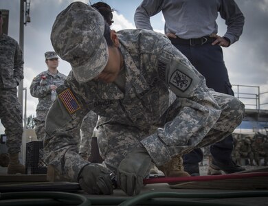 U.S. Army Reserve Spc. Daisy Garcia, 329th Chemical Company chemical biological warfare specialist, prepares lifting equipment during hazardous material training on Miami-Dade Fire Rescue headquarters, Miami, Fl. Feb 17, 2016. These training events were held by fire rescue personnel in preparation for a validation exercise held by U.S. Army North and U.S. Northern Command. 