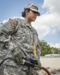 U.S. Army Reserve Spc. Daisy Garcia, 329th Chemical Company chemical biological warfare specialist, operates lifting equipment during hazardous material training on Miami-Dade Fire Rescue headquarters, Miami, Fl. Feb 17, 2016. These training events were held by fire rescue personnel in preparation for a validation exercise held by U.S. Army North and U.S. Northern Command. 