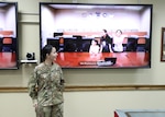 Air Force Tech. Sgt. Janet Pelayo, Defense Logistics Agency Aviation, celebrates her promotion ceremony Jan 31, 2017 held at Camp Arifjan, Kuwait, with her daughters watching through the use of video teleconferencing technology at Defense Supply Center Richmond, Virginia.