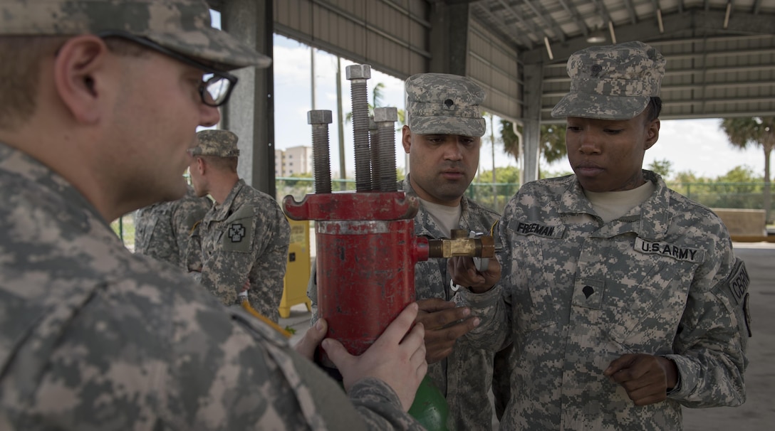 U.S. Army Reserve 329th Chemical Company soldiers secure a container leak during hazardous material training on Miami-Dade Fire Rescue headquarters, Miami, Fl. Feb 17, 2016. These training events were held by fire rescue personnel in preparation for a validation exercise held by U.S. Army North and U.S. Northern Command. 