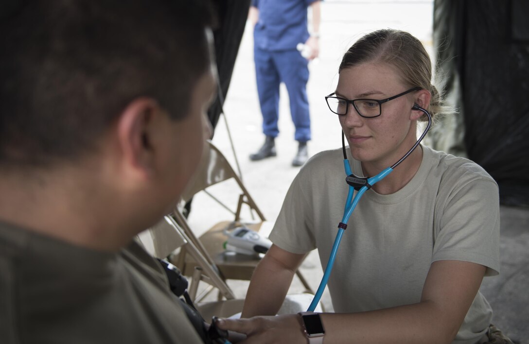 U.S. Army Reserve Spc. Callie Harper, 469th Medical Company medic, monitors Spc. Jaime Alamos, 329th Chemical Company chemical biological warfare specialist’s, vitals during a hazardous material decontamination exercise on the Port of Miami, Fla. Feb 18, 2017. The exercise was led by Miami-Dade Fire Rescue and U.S. Army North under the supervision of U.S. Northern Command and provided soldiers and first responders the unique experience of operating together in a major metropolitan city. 