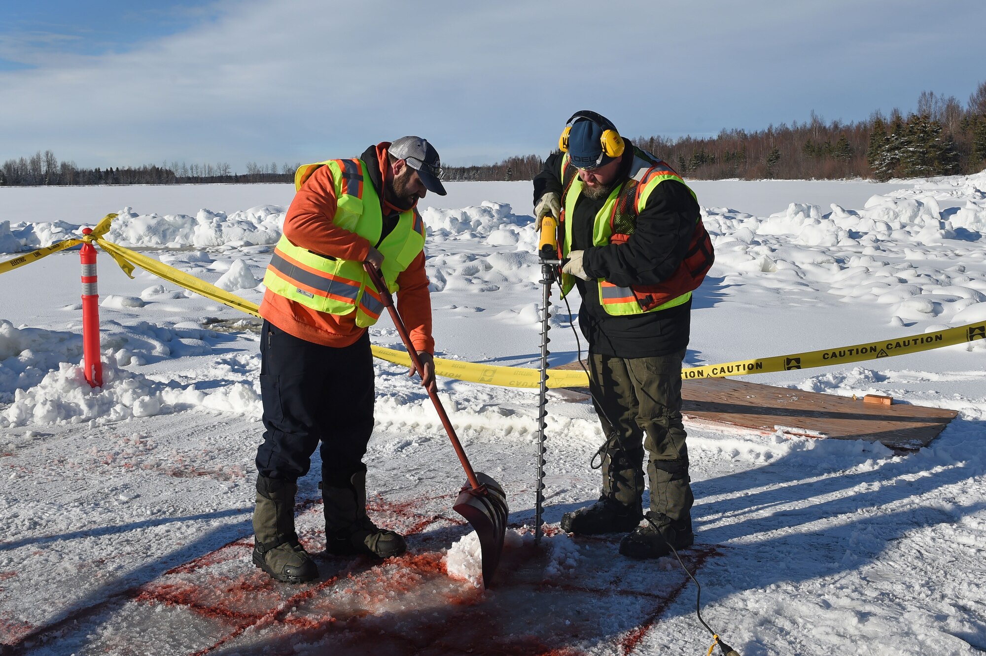 Members of the 611th Civil Engineer Squadron, U.S. Navy Supervisor of Salvage, U.S. Coast Guard, Alaska Department of Environmental Conservation, and the U.S. Environmental Protection Agency, participate in an arctic response training exercise at Sixmile Lake at Joint Base Elmendorf-Richardson, Alaska, Feb. 15, 2017. The training involved learning oil-spill response techniques on the ice and crisis response methods during arctic conditions. 