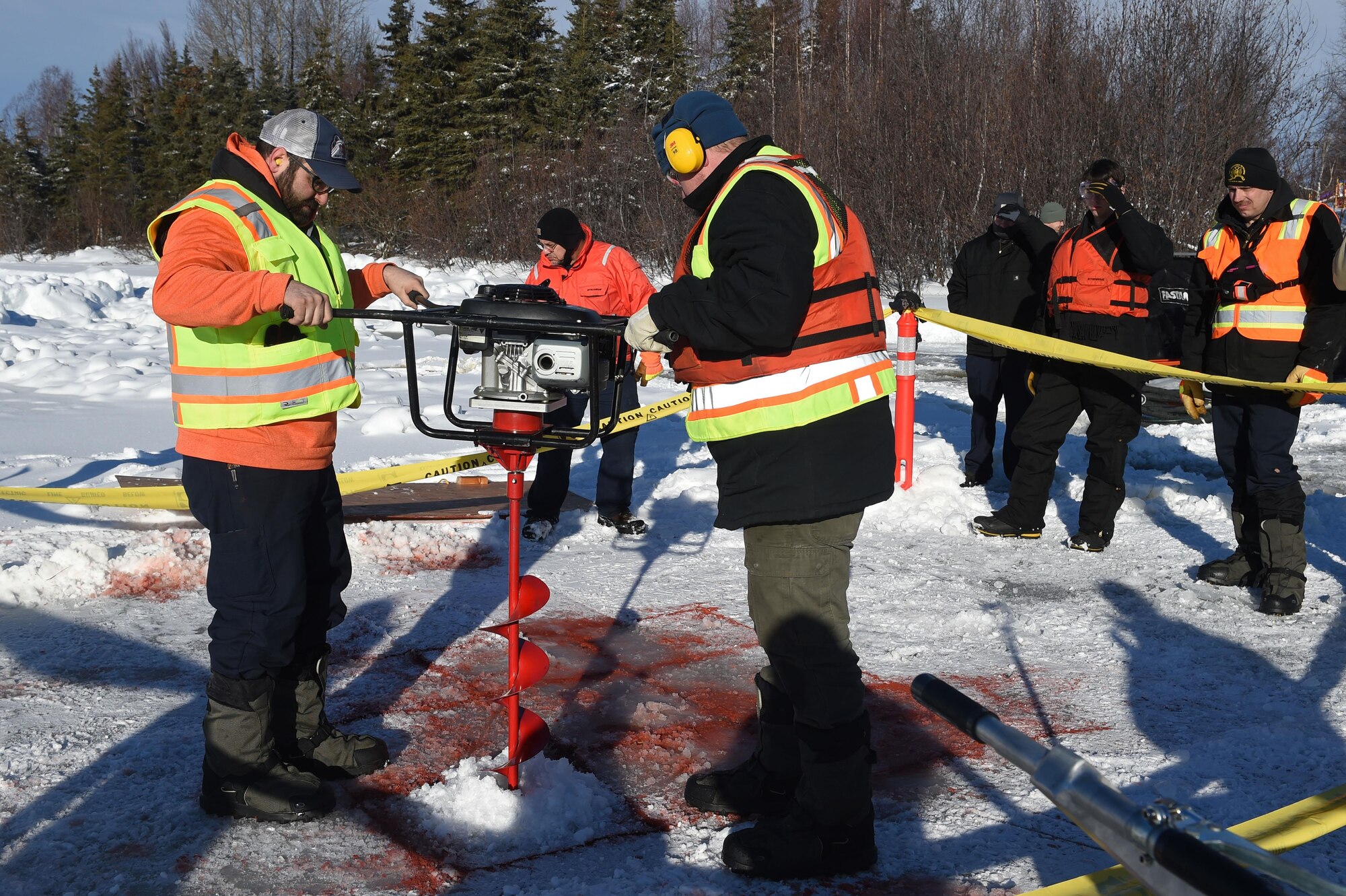 Members of the 611th Civil Engineer Squadron, U.S. Navy Supervisor of Salvage, U.S. Coast Guard, Alaska Department of Environmental Conservation, and the U.S. Environmental Protection Agency, participate in an arctic response training exercise at Sixmile Lake at Joint Base Elmendorf-Richardson, Alaska, Feb. 15, 2017. The training involved learning oil-spill response techniques on the ice and crisis response methods during arctic conditions. 