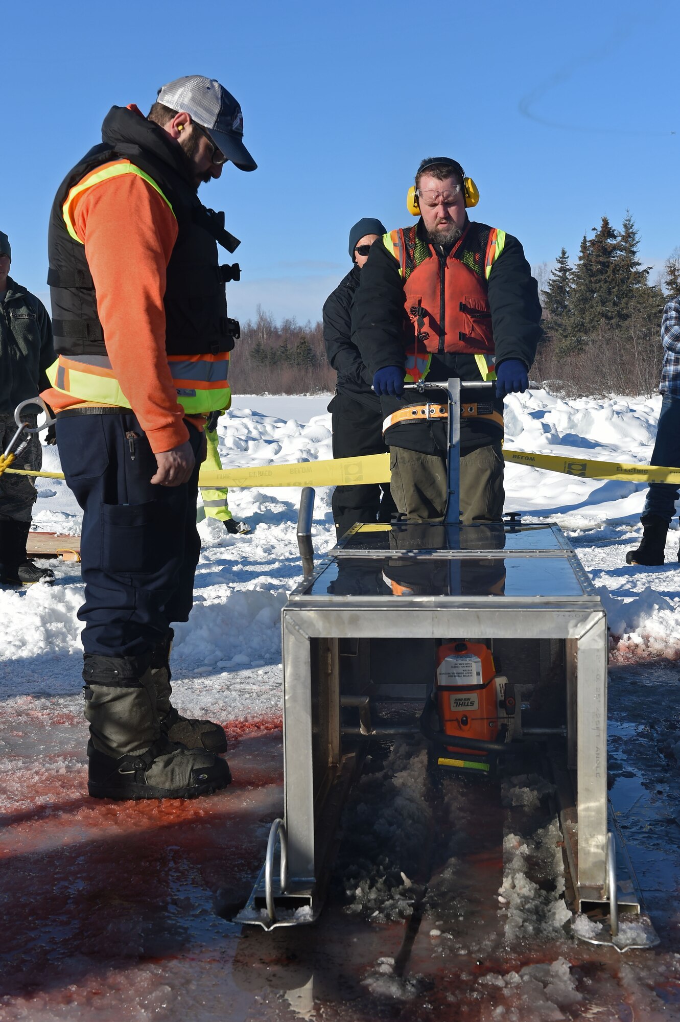 Members of the 611th Civil Engineer Squadron, U.S. Navy Supervisor of Salvage, U.S. Coast Guard, Alaska Department of Environmental Conservation, and the U.S. Environmental Protection Agency, participate in an arctic response training exercise at Sixmile Lake at Joint Base Elmendorf-Richardson, Alaska, Feb. 15, 2017. The training involved learning oil-spill response techniques on the ice and crisis response methods during arctic conditions. 