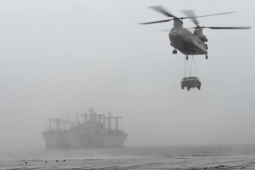 A U.S. Army CH-47 Chinook helicopter transports a Humvee vehicle to a floating causeway on the James River as part of a sling-load operations exercise at Joint Base Langley-Eustis, Va., Feb. 15, 2017. The exercise involved multiple units within the 7th Transportation Brigade (Expeditionary) such as the 1098th Transportation Company (Medium Watercraft) which supplied the LCM-8 Mike boats and the 5th Battalion, 159th Aviation Regiment which supplied the helicopter. (U.S. Air Force photo by Airman 1st Class Kaylee Dubois) 