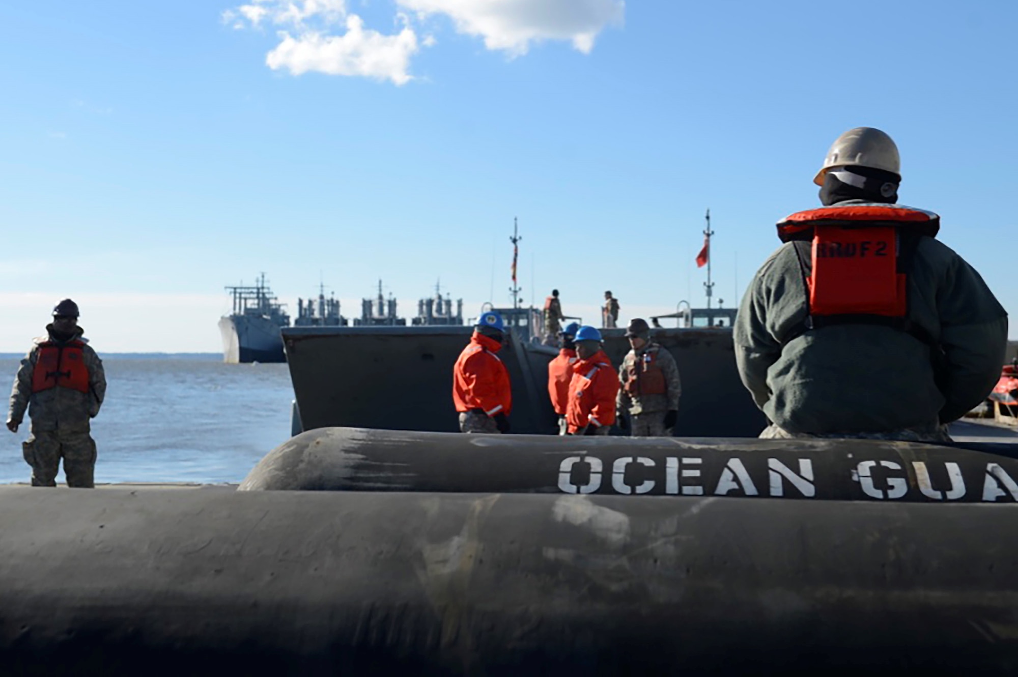U.S. Army Soldiers pause before disassembling the floating causeway after a sling-load exercise at Joint Base Langley-Eustis, Va., Feb. 15, 2017. The floating causeway will be transported back to 3rd Port and dissemble piece by piece. (U.S. Air Force photo by Airman 1st Class Kaylee Dubois)