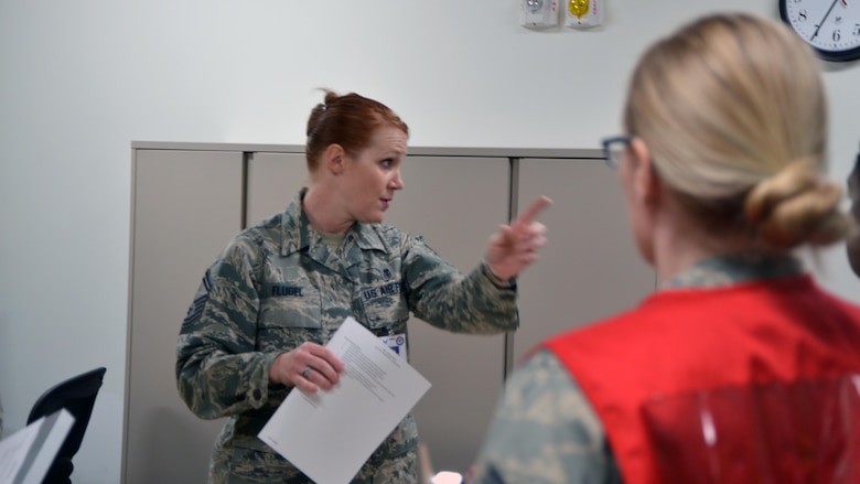 Senior Master Sgt. Jodi Flugel, 377 Aerospace Medicine Squadron superintendent, instructs the Wing Inspection Team on the details of the active shooter exercise, Feb. 21. The exercise gave a realistic active shooter scenario for both security forces and medical personnel to respond to. (U.S. Air Force Photo/Senior Airman Chandler Baker)