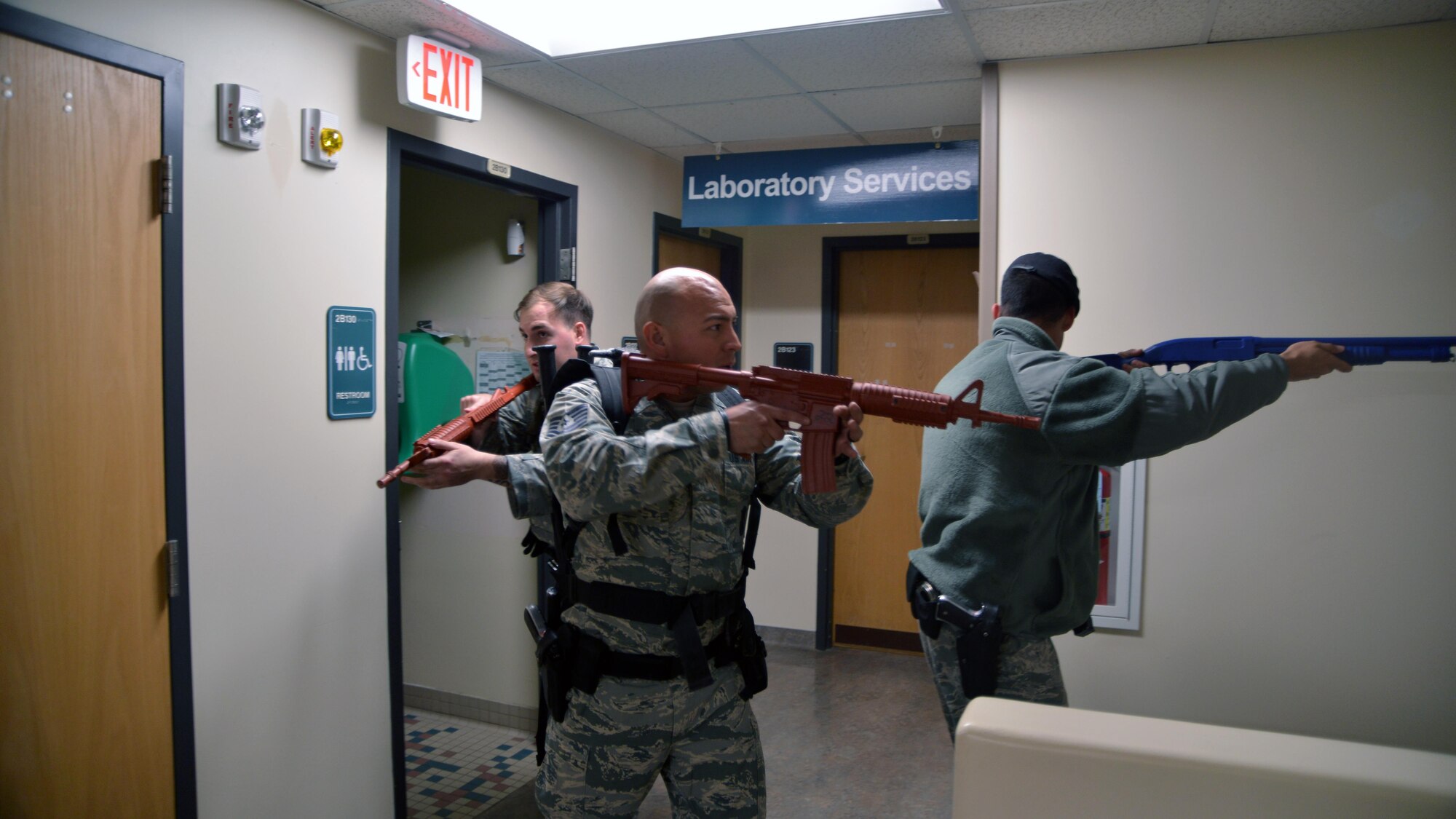 Defenders from the 377 Security Forces Squadron clear hallways inside the 377 Medical Group Clinic during an active shooter exercise Feb. 21. It took defenders 15 minutes to locate and disarm the shooter during the exercise. (U.S. Air Force Photo/ Senior Airman Chandler Baker)