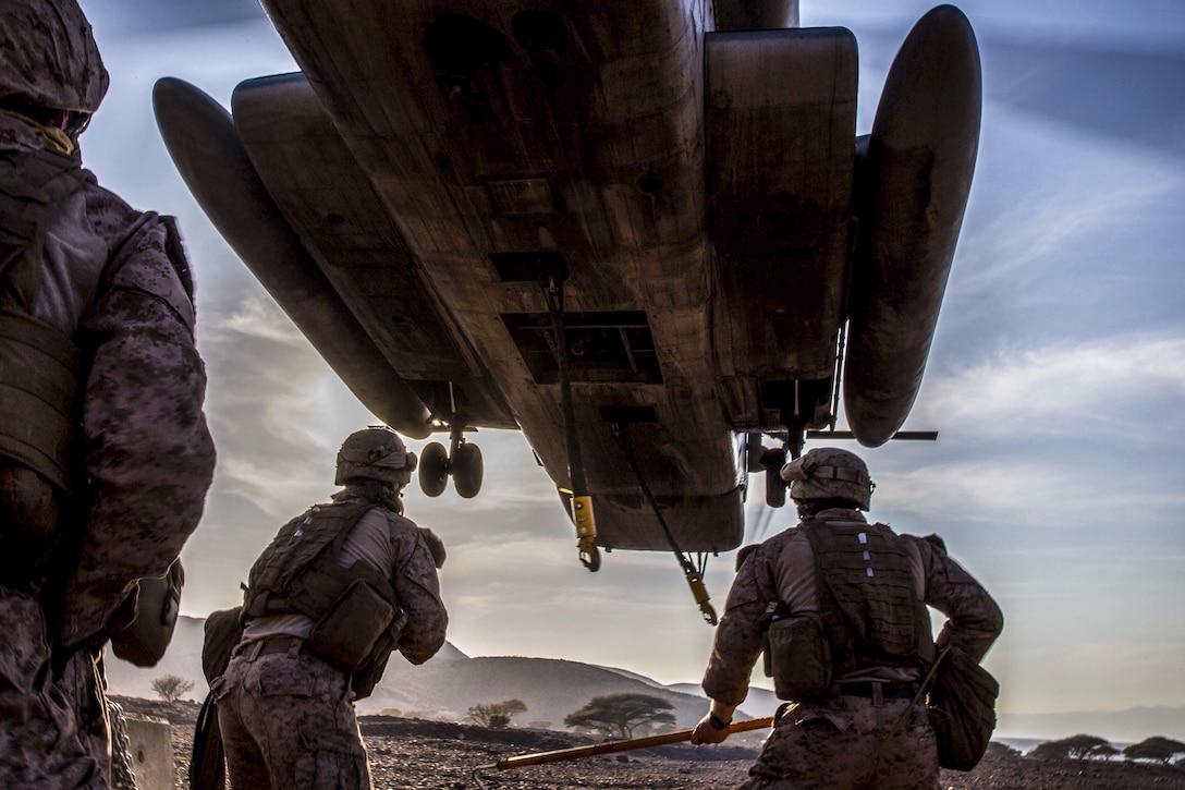 Marines prepare to attach a concrete barrier to a CH-53E Super Stallion during helicopter external load training at Arta Beach, Djibouti, Feb. 16, 2017. The Marines are assigned to Combat Logistics Battalion 11, and the Stallion and crew are assigned to Marine Medium Tiltrotor Squadron 163 (Reinforced), 11th Marine Expeditionary Unit. Marine Corps photo by Lance Cpl. Brandon Maldonado