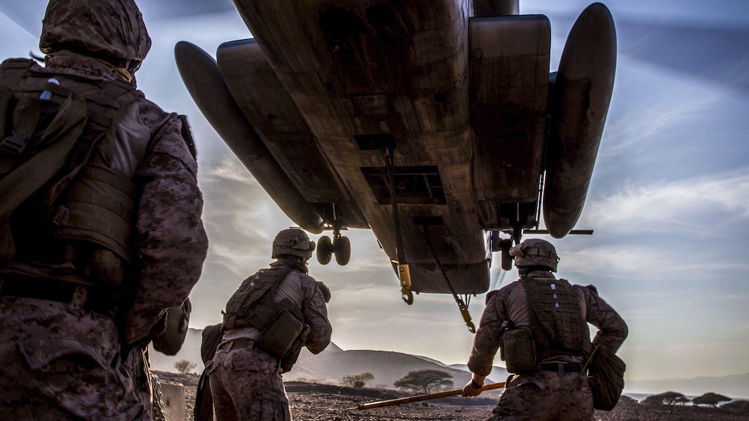 Marines prepare to attach a concrete barrier to a CH-53E Super Stallion during helicopter external load training at Arta Beach, Djibouti, Feb. 16, 2017. The Marines are assigned to Combat Logistics Battalion 11, and the Stallion and crew are assigned to Marine Medium Tiltrotor Squadron 163 (Reinforced), 11th Marine Expeditionary Unit. Marine Corps photo by Lance Cpl. Brandon Maldonado