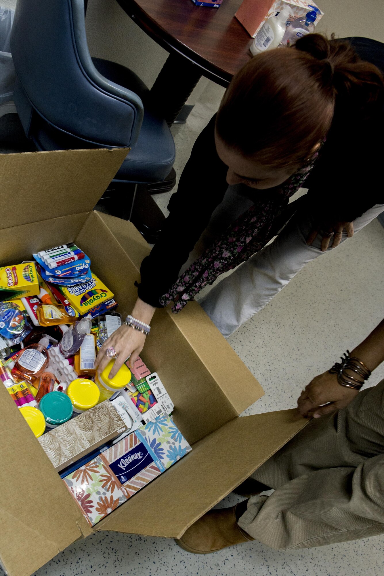 A teacher from West Elementary School looks over donated school supplies from the 374th Logistics and Readiness Squadrons Rising Six’s Holiday Teacher Drive Feb. 15, 2017, at Yokota Air Base, Japan. Seven members from the Rising Six gathered $2,400 worth of school supplies and $300 for Yokota Air Base schools. (U.S. Air Force Photos by Airman 1st Class Donald Hudson)