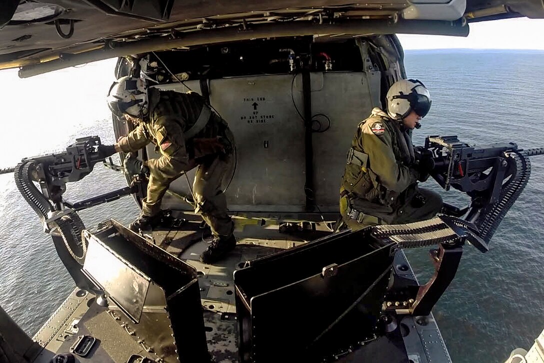 Navy Petty Officer 1st Class Derik Richardson, right, and Petty Officer 2nd Class Kevin Brodwater conduct a live-fire exercise from an MH-60S Seahawk helicopter over the South China Sea, Feb. 21, 2017. Richardson and Brodwater, both naval aircrewmen (helicopter), are assigned to the USS Coronado. The littoral combat ship is a fast and agile warship, providing the U.S. 7th Fleet with flexible capabilities. Navy photo by Petty Officer 2nd Class Amy M. Ressler