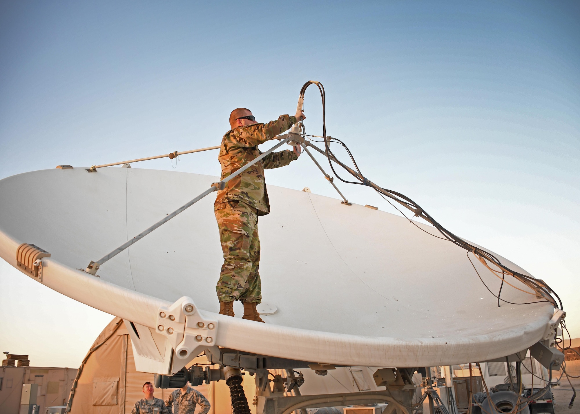 U.S. Air Force Staff Sgt. Jeff Schumacher, a Raiders Deployable Ground Segment-0 crew chief with the 379th Expeditionary Operations Support Squadron, attaches a low noise amplifier to an antenna at Al Udeid Air Base, Qatar, Jan. 30, 2017. These antennas are used in Operation Silent Sentry and help detect and geolocate electromagnetic interference to signals of interest. (U.S. Air Force photo by Senior Airman Miles Wilson)