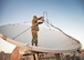 U.S. Air Force Staff Sgt. Jeff Schumacher, a Raiders Deployable Ground Segment-0 crew chief with the 379th Expeditionary Operations Support Squadron, attaches a low noise amplifier to an antenna at Al Udeid Air Base, Qatar, Jan. 30, 2017. These antennas are used in Operation Silent Sentry and help detect and geolocate electromagnetic interference to signals of interest. (U.S. Air Force photo by Senior Airman Miles Wilson)