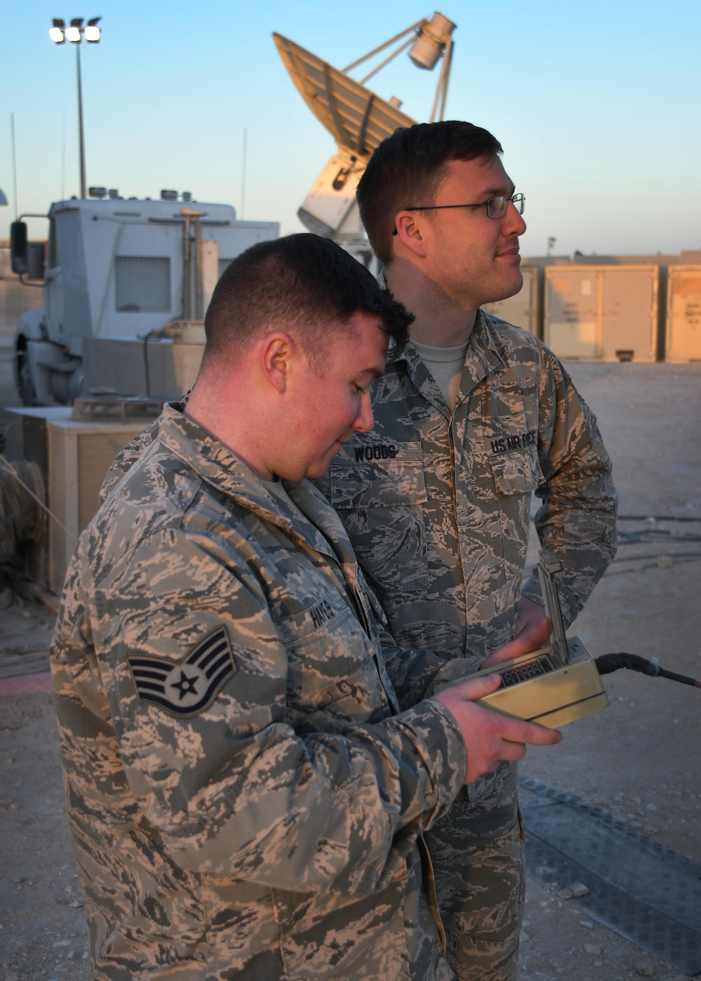 U.S. Air Force Staff Sgt. Chris Hayes, a Bounty Hunter crew chief, and U.S. Air Force Staff Sgt. Lucas Woods, a defensive space control maintainer, both with the 379th Expeditionary Operations Support Squadron, use a control pad to redirect an antenna at Al Udeid Air Base, Qatar, Jan. 30, 2017. These antennas are an Operation Silent Sentry asset and help find and locate electromagnetic interference in the U.S. Central Command area of responsibility. (U.S. Air Force photo by Senior Airman Miles Wilson)
