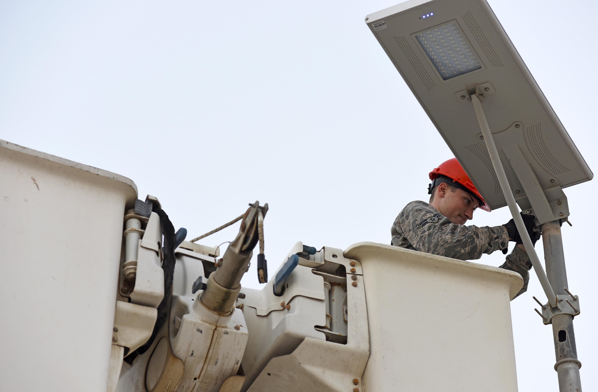 U.S. Air Force Airman 1st Class Corey Martin, an electrical systems apprentice with the 379th Expeditionary Civil Engineer Squadron, adjusts a light fixture at Al Udeid Air Base, Qatar, Feb. 22, 2017. This particular light fixture was a solar-powered low-emitting diode light that collects the sun’s energy during the day and stores it in a rechargeable battery cell.  (U.S. Air Force photo by Senior Airman Cynthia A. Innocenti)