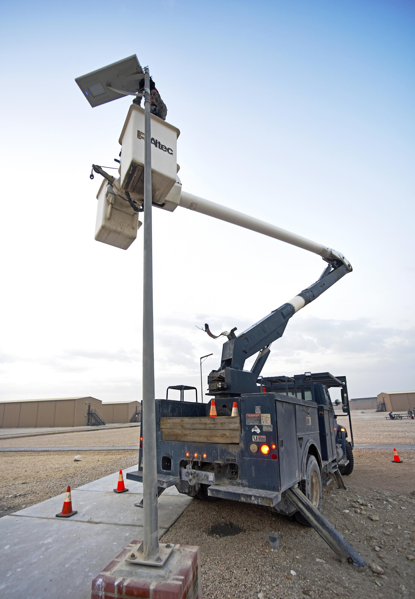 U.S. Air Force Airman 1st Class Corey Martin, an electrical systems apprentice with the 379th Expeditionary Civil Engineer Squadron, adjusts a light fixture at Al Udeid Air Base, Qatar, Feb. 22, 2017. This particular light fixture was a solar-powered low-emitting diode light that collects the sun’s energy during the day and stores it in a rechargeable battery cell.  (U.S. Air Force photo by Senior Airman Cynthia A. Innocenti)