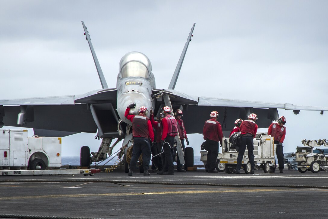 Sailors prepare to load ammunition on an FA-18F Super Hornet on the flight deck of the aircraft carrier USS Carl Vinson in the Philippine Sea, Feb. 15, 2017. The sailors are aviation ordnancemen assigned to Strike Fighter Squadron 2. Navy photo by Seaman Jake Cannady 