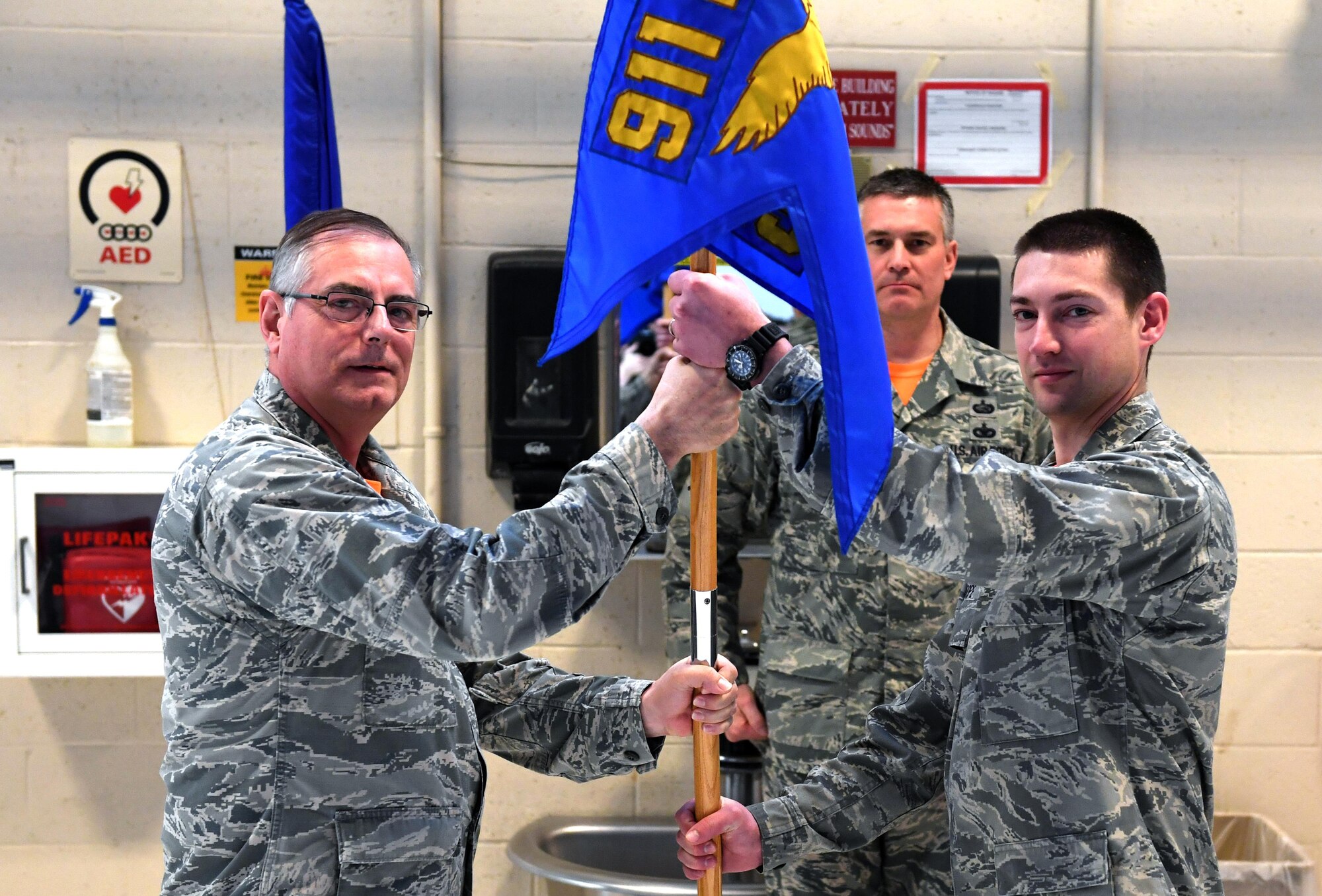 Capt. Dustin Pope accepts the 911th Maintenance Squadron guideon from Col. Clifford Waller, commander of the 911th Maintenance Group, during an assumption of command ceremony at the Pittsburgh International Airport Air Reserve Station, Feb. 12, 2017. Pope, who has been a member of the 911th Airlift Wing for several years, assumed command of the squadron from Maj. William Chapman. (U.S. Air Force photo by Staff Sgt. Marjorie A. Bowlden)