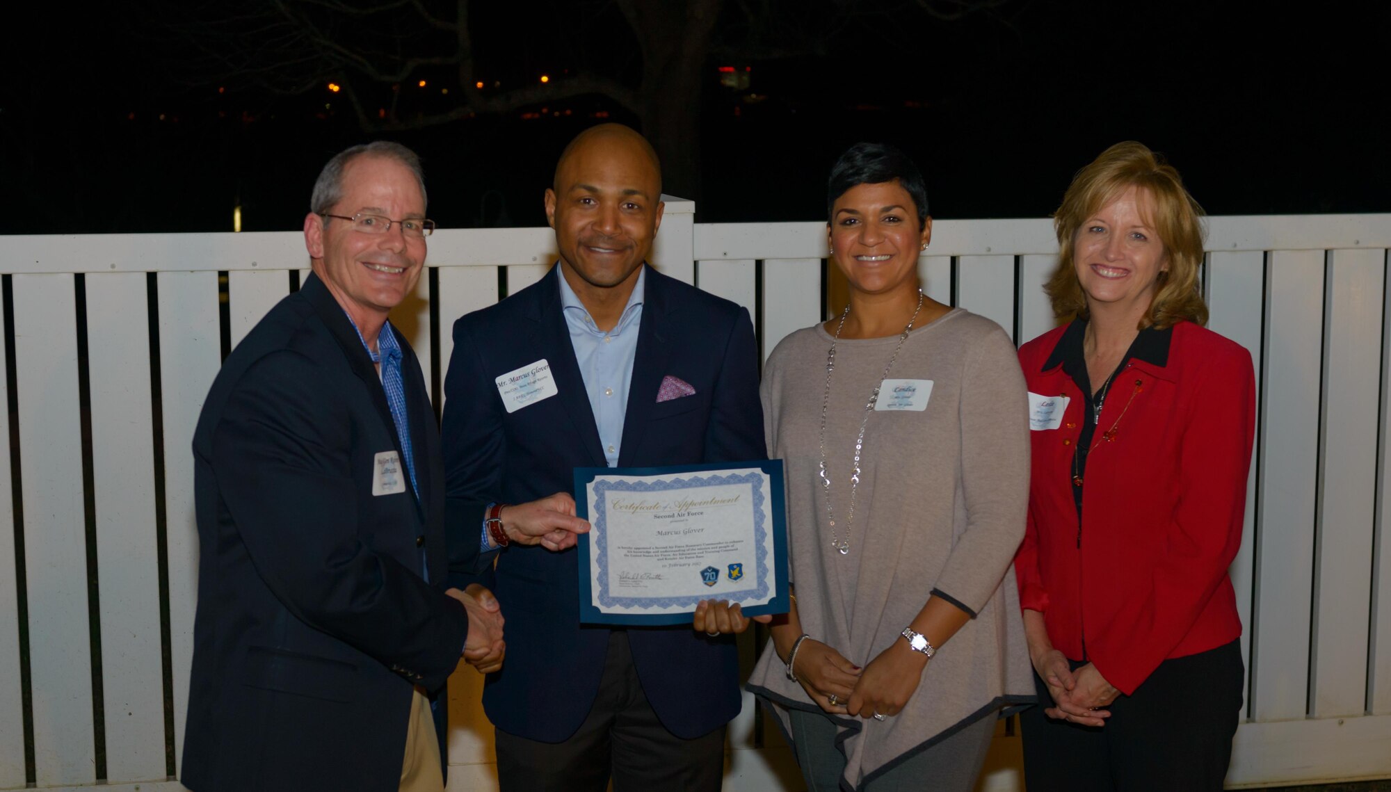 Maj. Gen. Robert LaBrutta, 2nd Air Force commander, and his wife, Leslie, pose for a photo with Marcus Glover, Beau Rivage Resorts, LLC, president and chief operating officer, and his wife, Candice, during the 81st TRW Honorary Commander Program induction ceremony Feb. 10, 2017, at Keesler Air Force Base, Miss. The Honorary Commander Program is a tool to help military and community leaders partner together to increase base involvement in civic endeavors and organizations and to further local community members’ understanding of the base’s mission.  (U.S. Air Force photo by Andre’ Askew) 