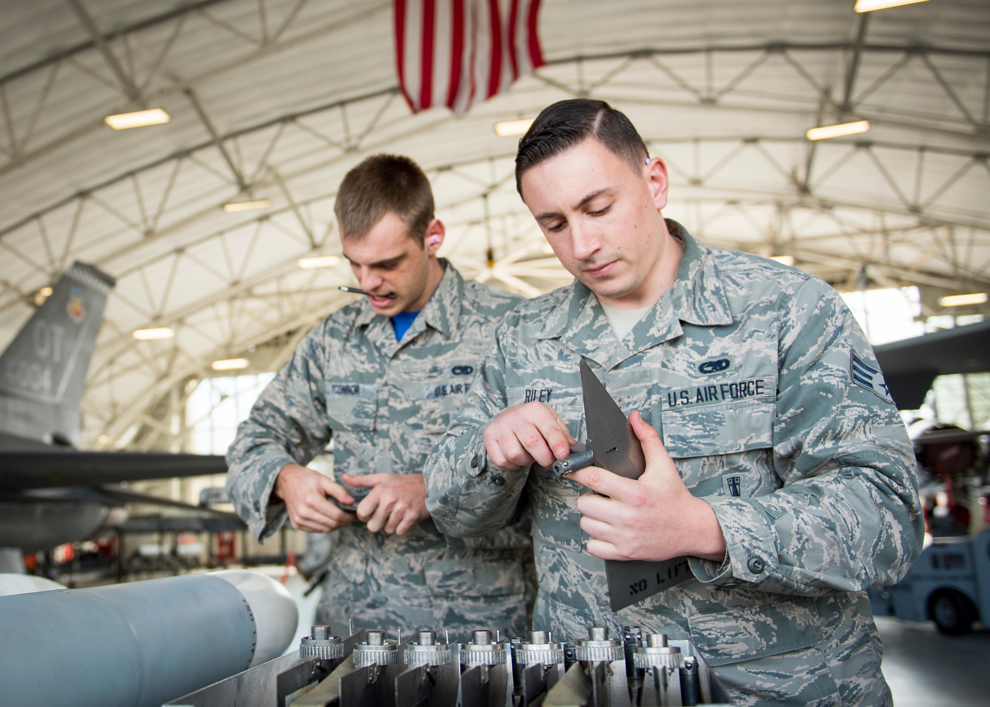 Senior Airman Trey Riley and Staff Sgt. Benjamin O’Connor, 96th Aircraft Maintenance Squadron Blue Crew, prepare the fins for an AIM-120 missile during a weapons load competition Feb. 17 at Eglin Air Force Base, Fla. The 30-minute competition tests the knowledge and proficiency of the crews. The annual competition also identifies the load crew of the year and earns them bragging rights as the best of 22. The winning crew is scheduled to be announced at the Maintenance Professionals of the Year Banquet in March. (U.S. Air Force photo/Ilka Cole)