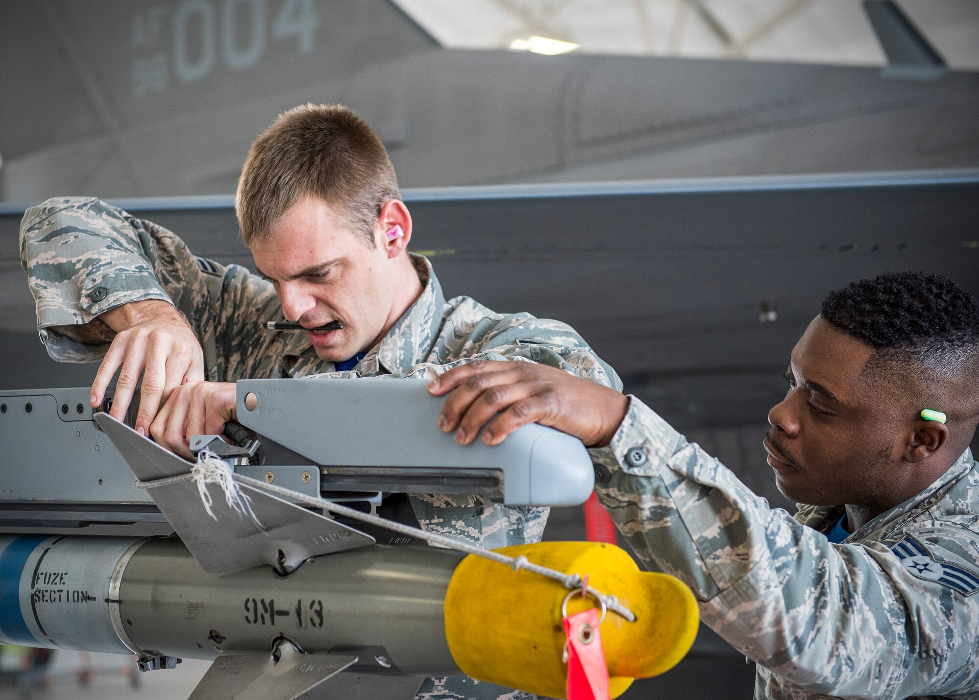 Staff Sgt. Benjamin O’Connor and Senior Airman David Johnson, 96th Aircraft Maintenance Squadron Blue Crew, load an AIM-9 missile on an F-16 Fighting Falcon during a weapons load competition Feb. 17 at Eglin Air Force Base, Fla. The 30-minute competition tests the knowledge and proficiency of the crews. The annual competition also identifies the load crew of the year and earns them bragging rights as the best of 22. The winning crew is scheduled to be announced at the Maintenance Professionals of the Year banquet in March. (U.S. Air Force photo/Ilka Cole)