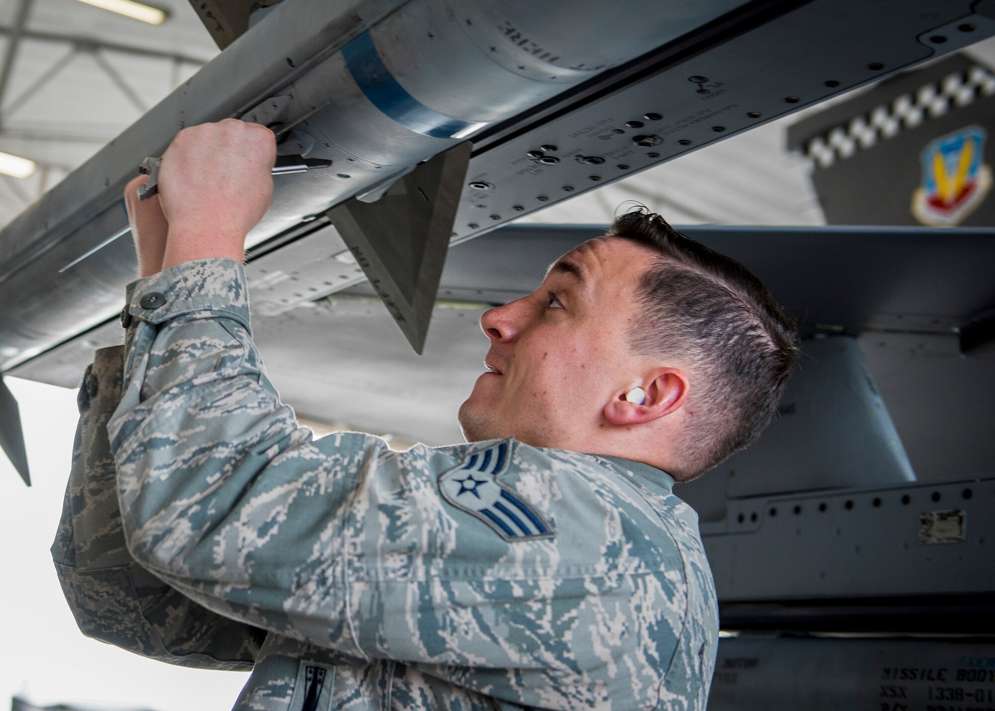 Senior Airman Trey Riley, 96th Aircraft Maintenance Squadron Blue Crew, secures the fins of an AIM-120 missile during a weapons load competition Feb. 17 at Eglin Air Force Base, Fla. The 30-minute competition tests the knowledge and proficiency of the crews. The annual competition also identifies the load crew of the year and earns them bragging rights as the best of 22. The winning crew is scheduled to be announced at the Maintenance Professionals of the Year Banquet in March. (U.S. Air Force photo/Ilka Cole)