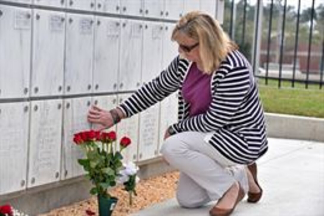 The daughter of Chief Master Sgt. Arthur Arehart Sr., U.S. Air Force, pays respect to her late father at the Barrancas National Cemetery at the Naval Air Station-Pensacola, Fl., Feb. 14. The final resting place for Arehart is in a section of columbarium that the U.S. Army Corps of Engineers, Mobile District, constructed last year.