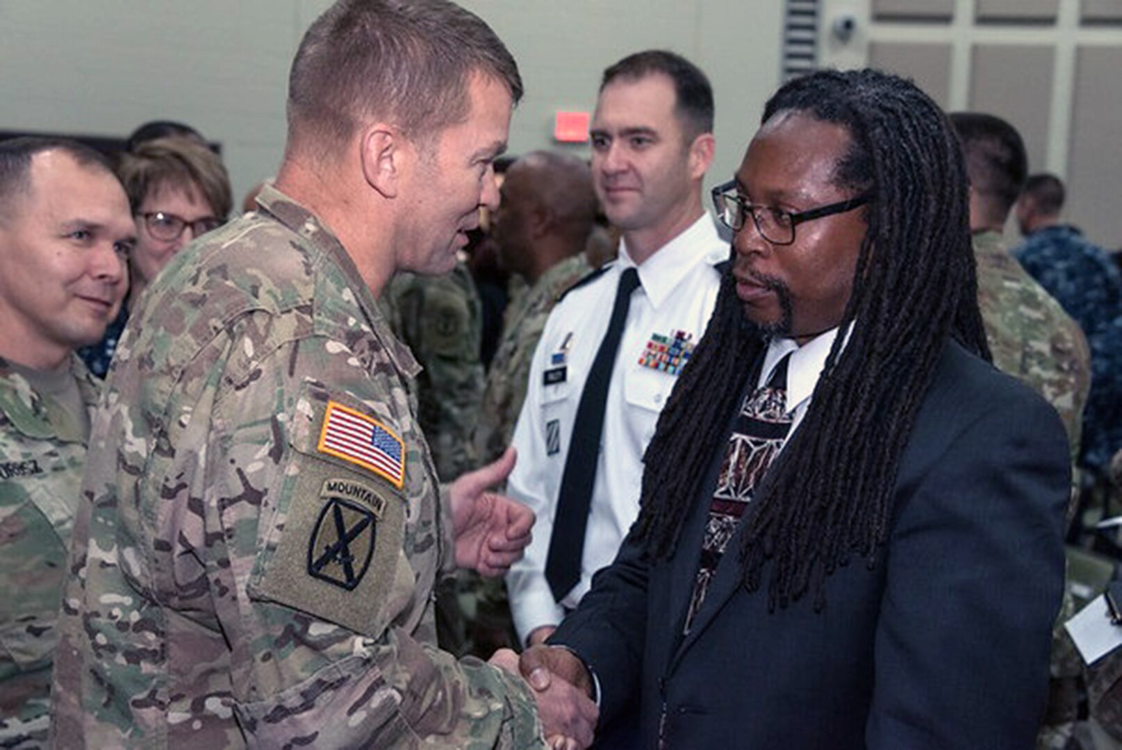 Lt. Gen. Jeffrey Buchanan (left), commanding general of U.S. Army North at Joint Base San Antonio-Fort Sam Houston, shakes the hand of Dr. Kevin Cokley, professor of African and African Diaspora Studies and Educational Psychology at the University of Texas at Austin, following Cokley's address to the Joint Base San Antonio Black History Month Observance, hosted by the 470th Military Intelligence Brigade Feb. 15. 