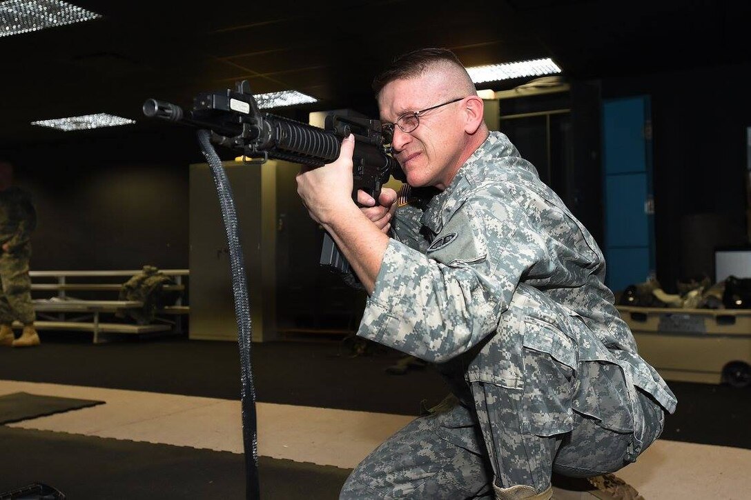 Sgt. 1st Class Kenneth Johnson, G3/Operations, engages targets during marksmanship training at the 85th Support Command's Engagement Skills Trainer-2000 facility, Feb. 12, 2017. The command's "Warrior Training Center's" (EST-2000) maintains superior accuracy and state of the art graphics. The facility allows soldiers to fire an array of different weapon systems and provides training of marksmanship, squad tactical, and close-range shoot-don't shoot techniques and skills for small arms weapons.
 The mission of this center is to conduct Basic Marksmanship Training for Soldiers with an end-state goal of improving individual marksmanship skills prior to units qualifying on a “live fire” range. The center is equipped with Laser Marksmanship Training System (LMTS) and staffed with trained instructors. The facility also houses a “Shoot House” allowing for hands on room clearing practice and procedures along with reflexive fire training utilizing Air Soft weapon systems.
(Photo by Sgt. Aaron Berogan)