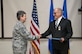 Gen. Ellen Pawlikowski congratulates Greg Gangnuss after presenting him with the Air Force Civilian Award for Valor during a Feb. 22 commander’s call at Joint Base San Antonio, Texas. Gangnuss served as a senior environmental advisor for the Ministry of Defense Advisor Program during his deployment. Pawlikowski is the commander of Air Force Materiel Command. 
(Courtesy photo)

