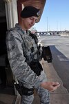 A1C Travis Cernetisch, assigned to the 802nd Security Forces Squadron, uses the latest Defense Biometrics Identification System (DBIDS) equipment to scan driver’s identification at JBSA-Lackland Kelly annex.  Airmen around the country are using the system to DBIDS as an enhanced security system used to monitor entry onto military installations. (US Air Force Photo/Annette Crawford)