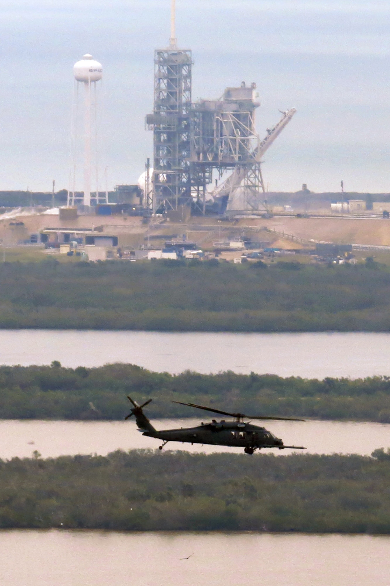 Lt. Cols. Michael Stucker and Gordon Schmidt, HH-60G Pave Hawk helicopter pilots with the 301st Rescue Squadron, clear the Eastern Range of boat traffic prior to the successful launch of the SpaceX Dragon spacecraft Feb. 19 at Cape Canaveral Air Force Station, Florida. (Photo by Carleton Bailie)