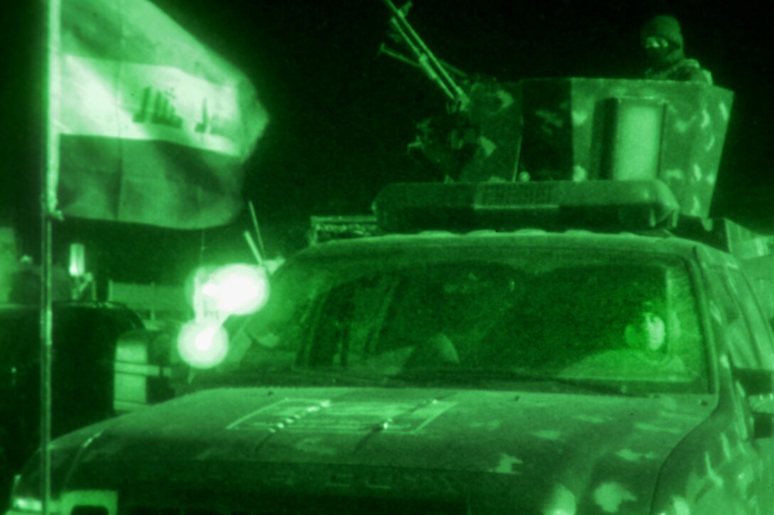 As seen through a night-vision device, Iraqi federal police provide security at the entrance of the Combined Joint Operations Center during an operational brief for the offensive into western Mosul at Hamam al-Alil, Iraq, Feb. 17, 2017. Army photo by Staff Sgt. Jason Hull 