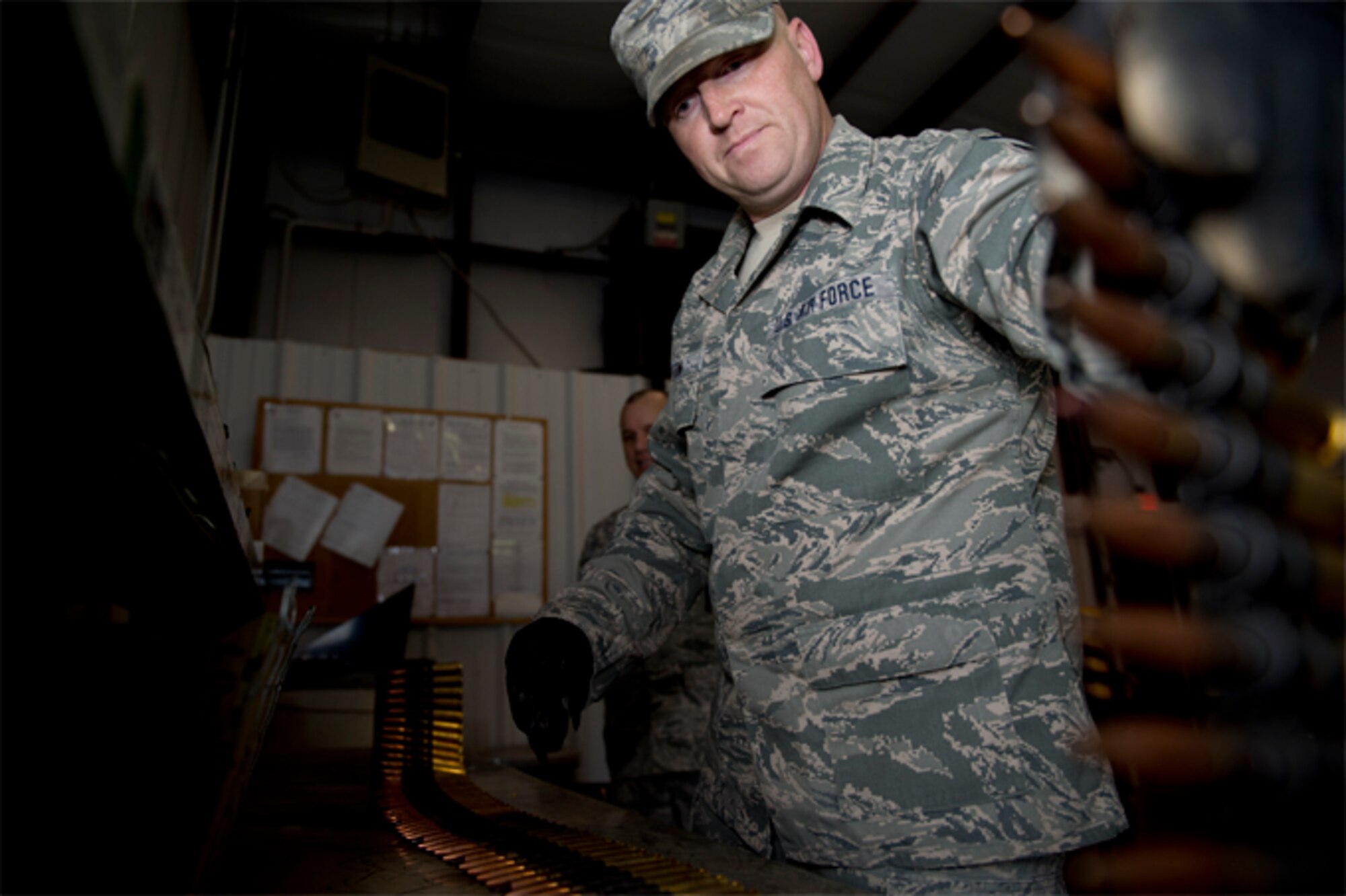 Master Sgt. Bobby Horton, 434th Maintenance Squadron munitions accountability supply officer, unrolls a belt of .50 caliber bullets for inspection at Grissom Air Reserve Base, Ind., Feb. 23, 2017. Horton and his munitions team are responsible for securing and maintaining the base's supply of ammunition and explosives, and performing regular checks on inventory. (U.S. Air Force photo/Senior Airman Harrison Withrow)