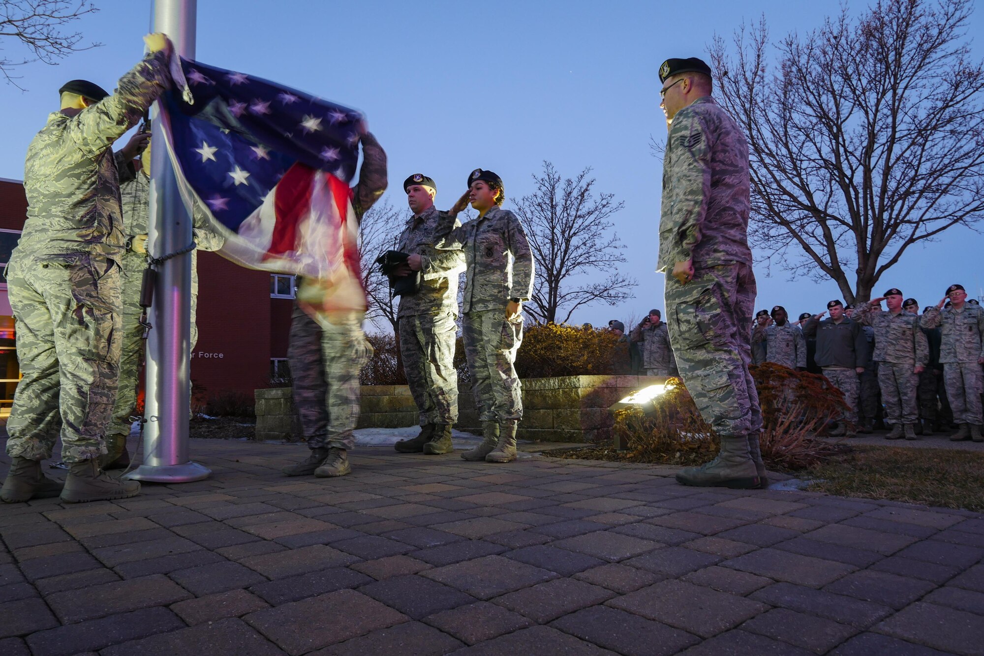 Defenders of the 934th Security Forces Squadron honor Old Glory during Reveille on Feb 12, 2017 signaling the official start of the duty day. (U.S. Air Force photo by Staff Sgt. Corban Lundborg) 
