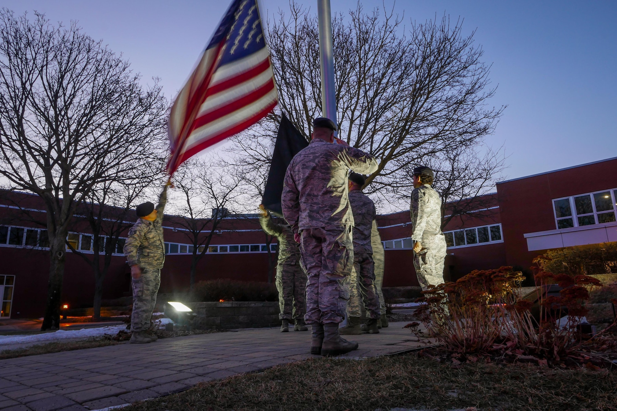 Defenders of the 934th Security Forces Squadron honor Old Glory during Reveille on Feb 12, 2017 signaling the official start of the duty day. (U.S. Air Force photo by Staff Sgt. Corban Lundborg) 
