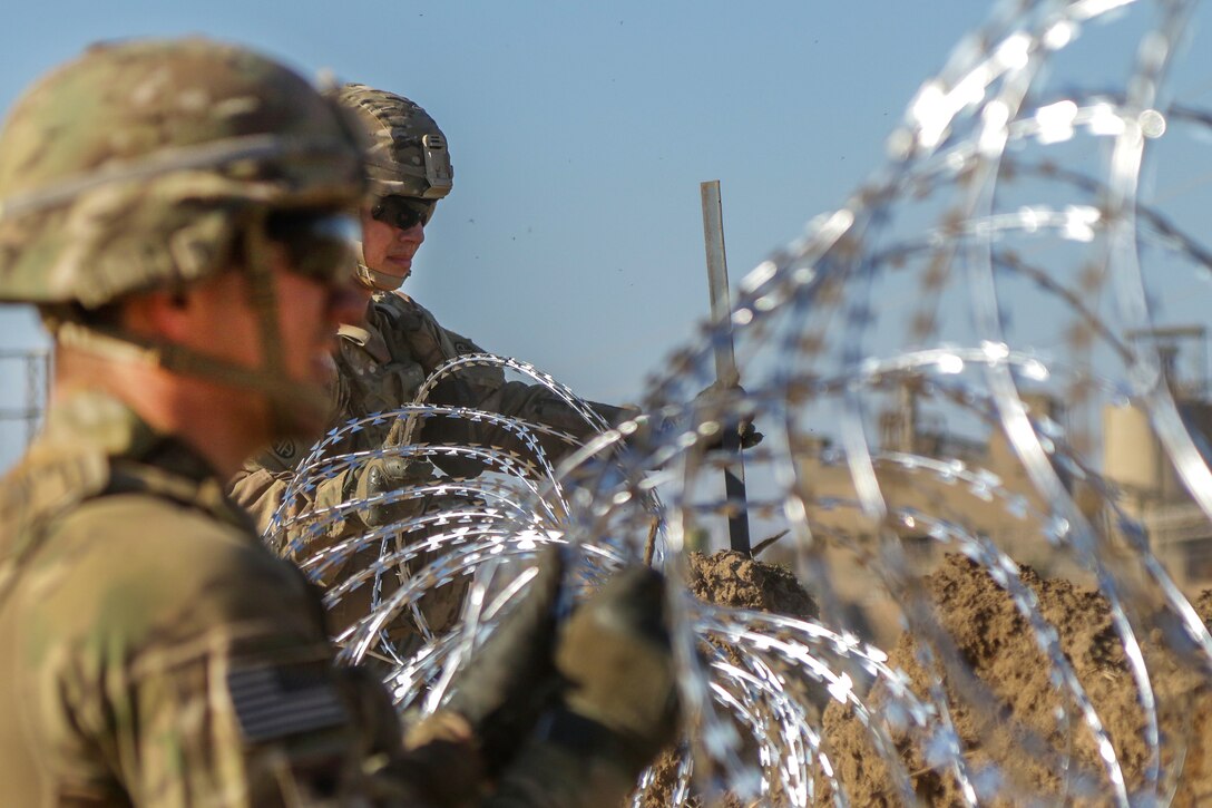 Army paratroopers reinforce the perimeter security by emplacing concertina wire at Hamam al-Alil, Iraq, Feb. 18, 2017. Army photo by Staff Sgt. Jason Hull 