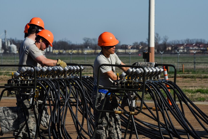 Air pressure valves are used to control and monitor the pressure in air lifts under a B-52 Stratofortress at Barksdale Air Force Base, La., Feb. 16, 2017. Three Airmen monitoring each of system had to communicate via radio to ensure the lifts remained balanced between each wing. (U.S. Air Force photo/Senior Airman Luke Hill)
