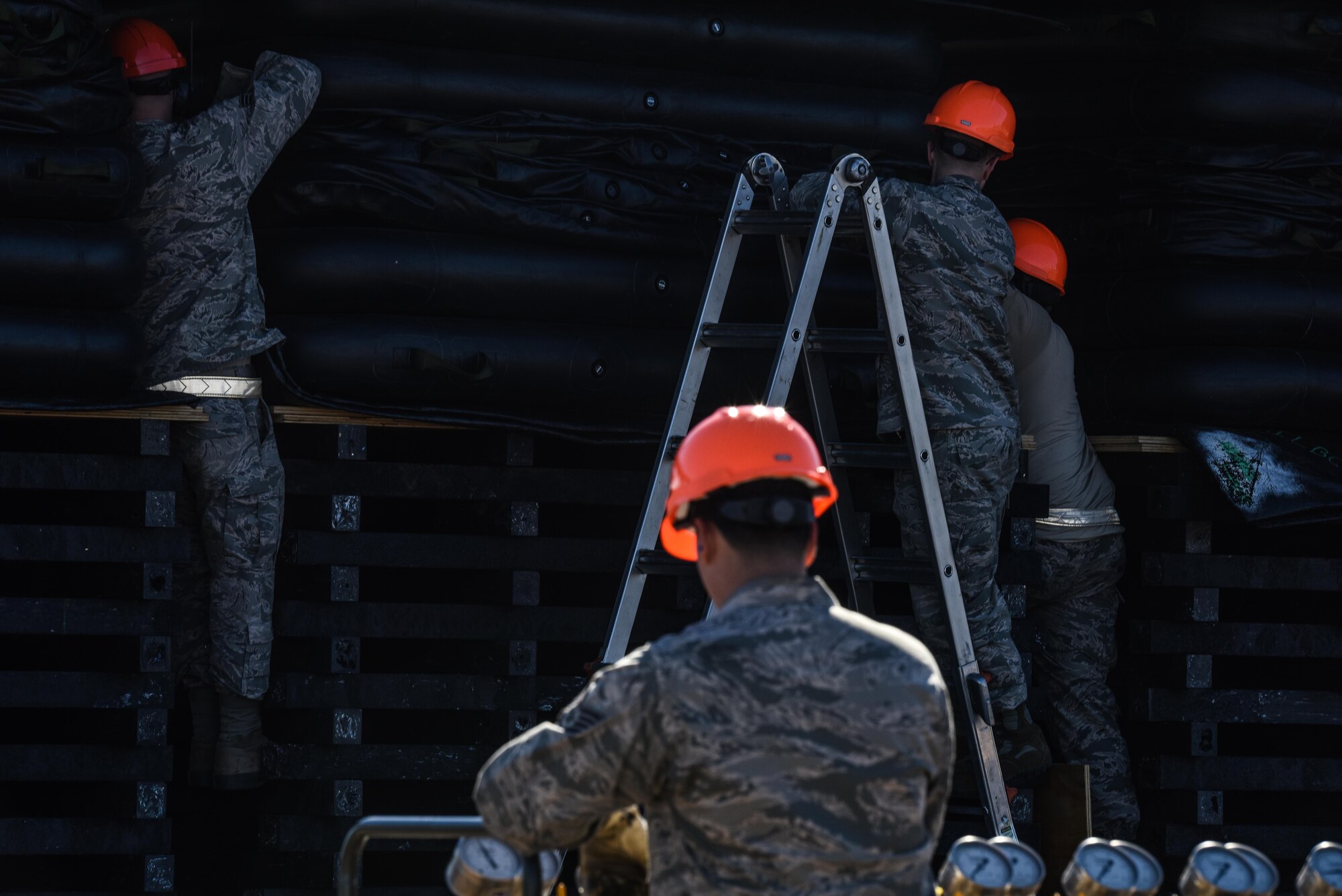 Air pressure valves are used to control and monitor the pressure in air lifts under a B-52 Stratofortress at Barksdale Air Force Base, La., Feb. 16, 2017. Three Airmen monitoring each of system had to communicate via radio to ensure the lifts remained balanced between each wing. (U.S. Air Force photo/Senior Airman Luke Hill)