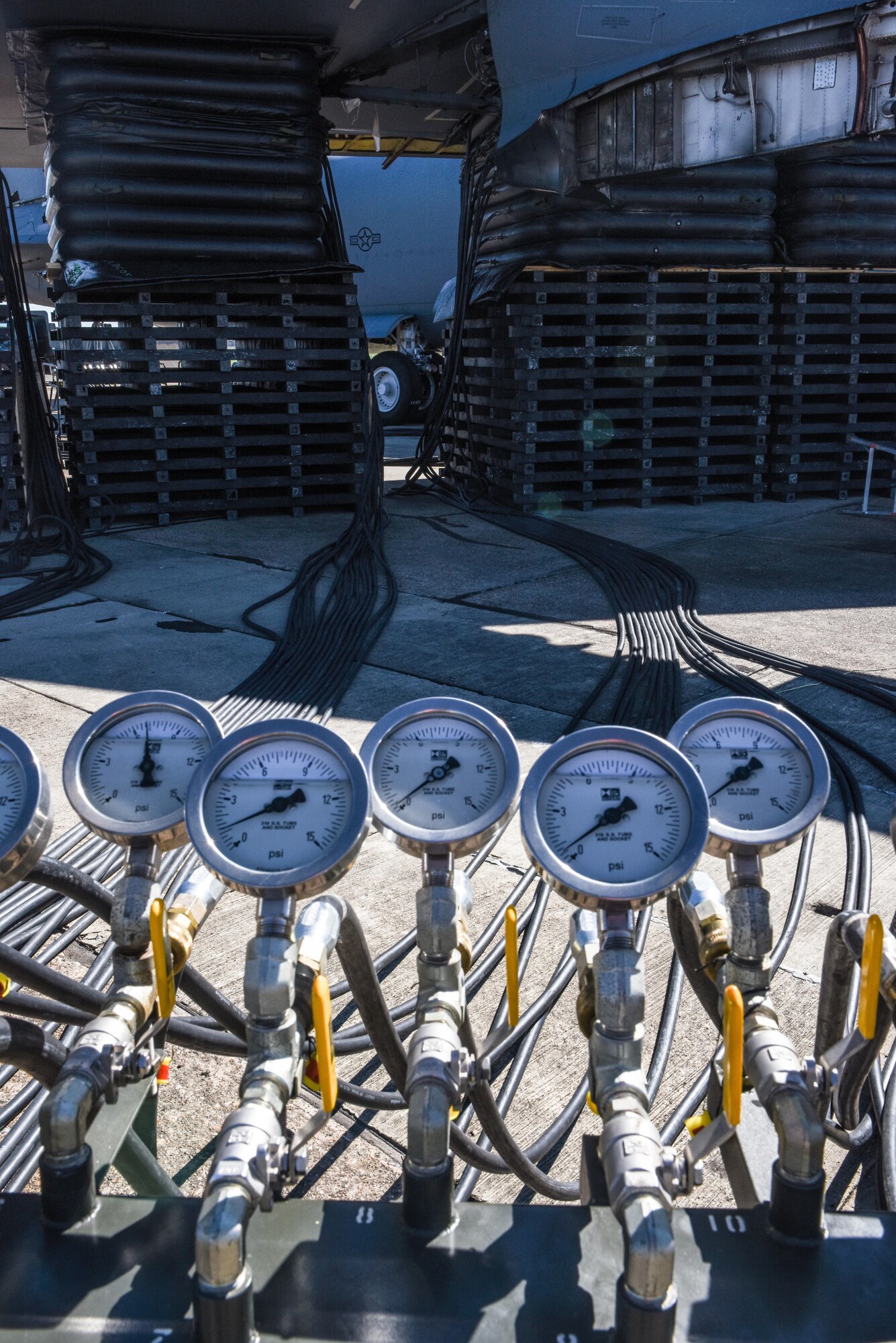 Air pressure valves are used to control and monitor the pressure in air lifts under a B-52 Stratofortress at Barksdale Air Force Base, La., Feb. 16, 2017. Three Airmen monitoring each of system had to communicate via radio to ensure the lifts remained balanced between each wing. (U.S. Air Force photo/Senior Airman Luke Hill)