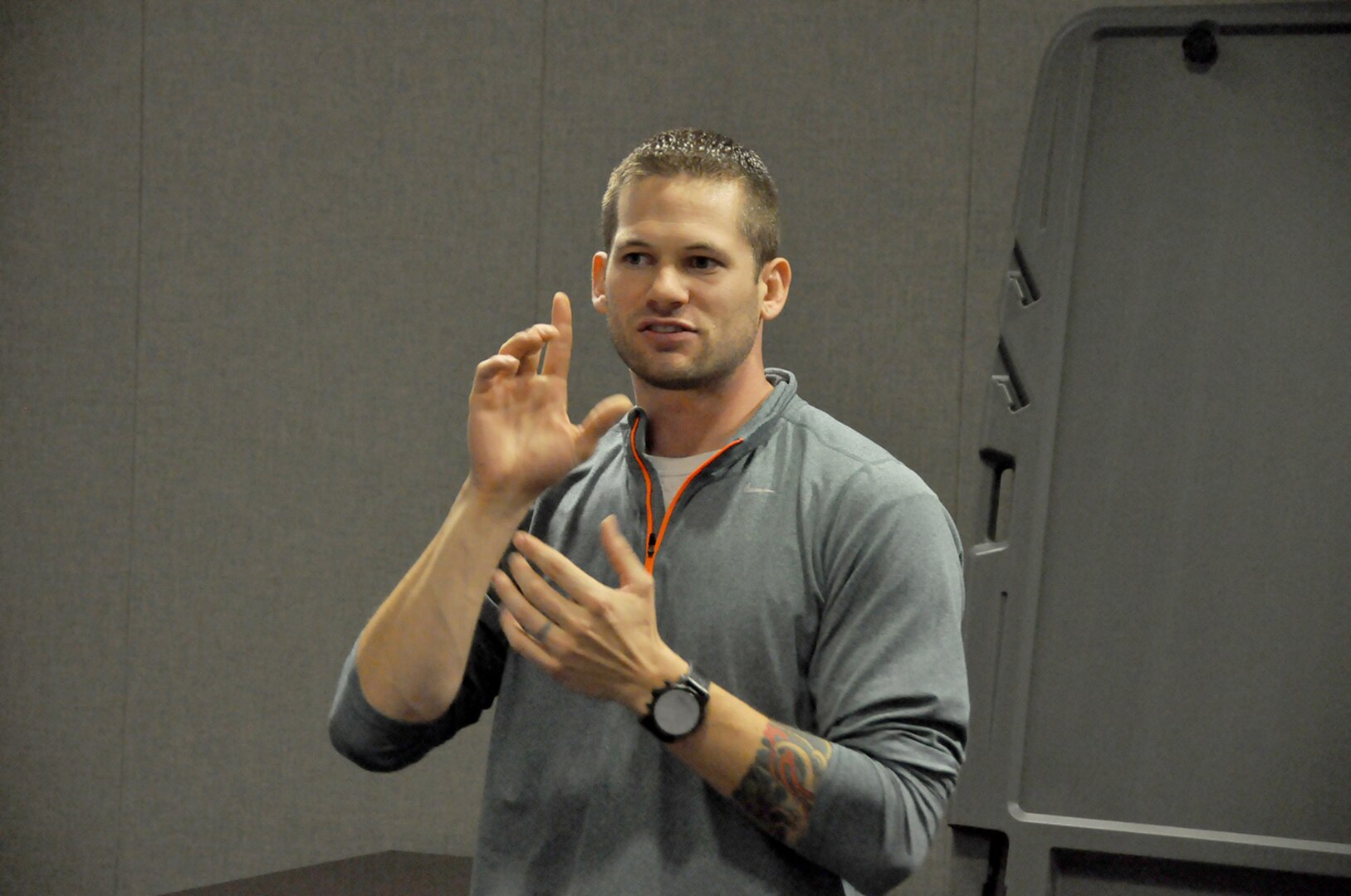 Business analyst Jarvis Beaver uses expressive body language to teach agency students American Sign Language.