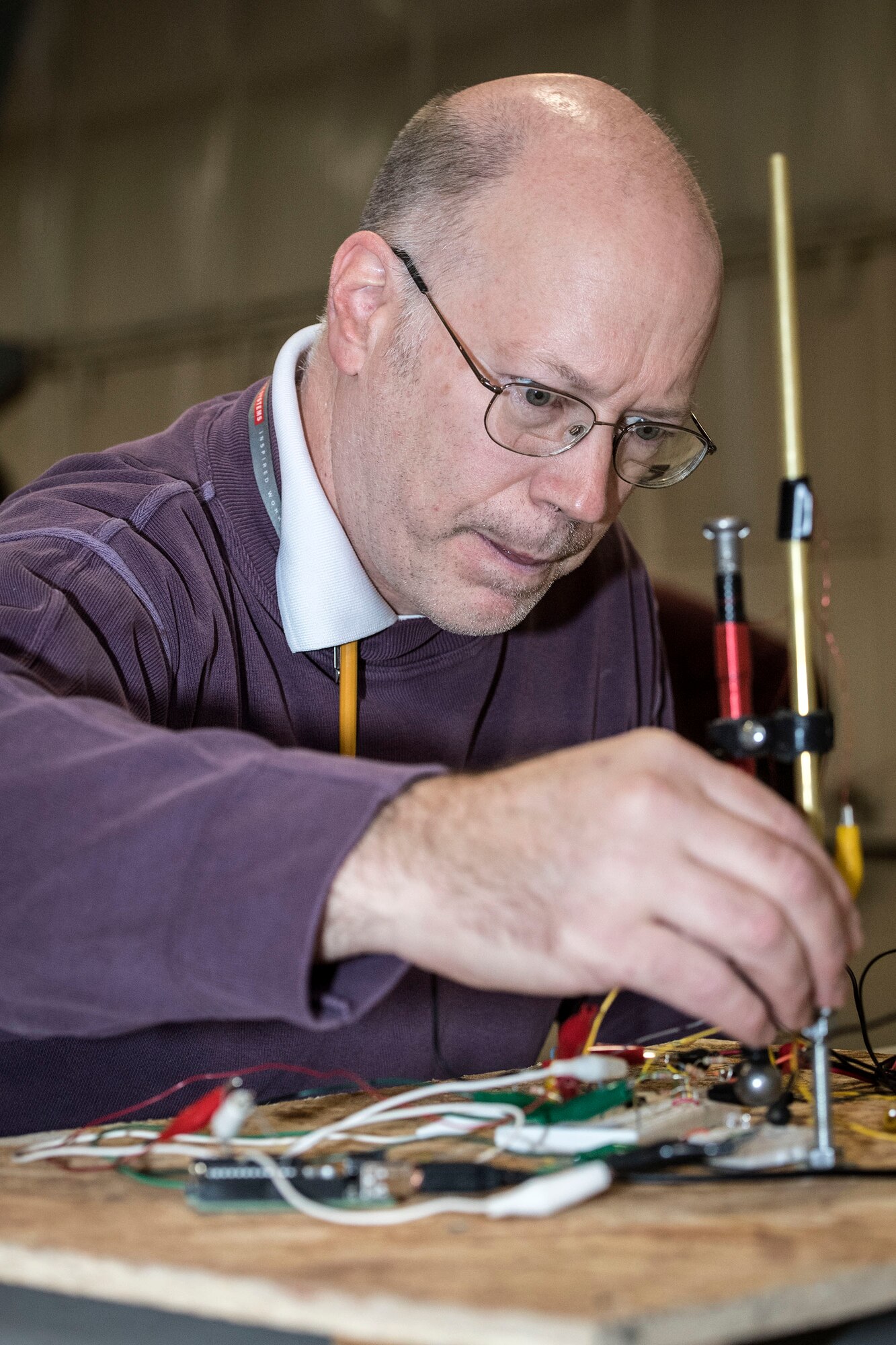 Casey Munger, Air Force Nuclear Weapons Center electronics engineer, makes adjustments to his magnetic levitation system Feb. 23 at the Hill Aerospace Museum. Munger was participating in Levitate!, a challenge that involved building and demonstrating  functional magnetic levitation system. (U.S. Air Force photo by Paul Holcomb)