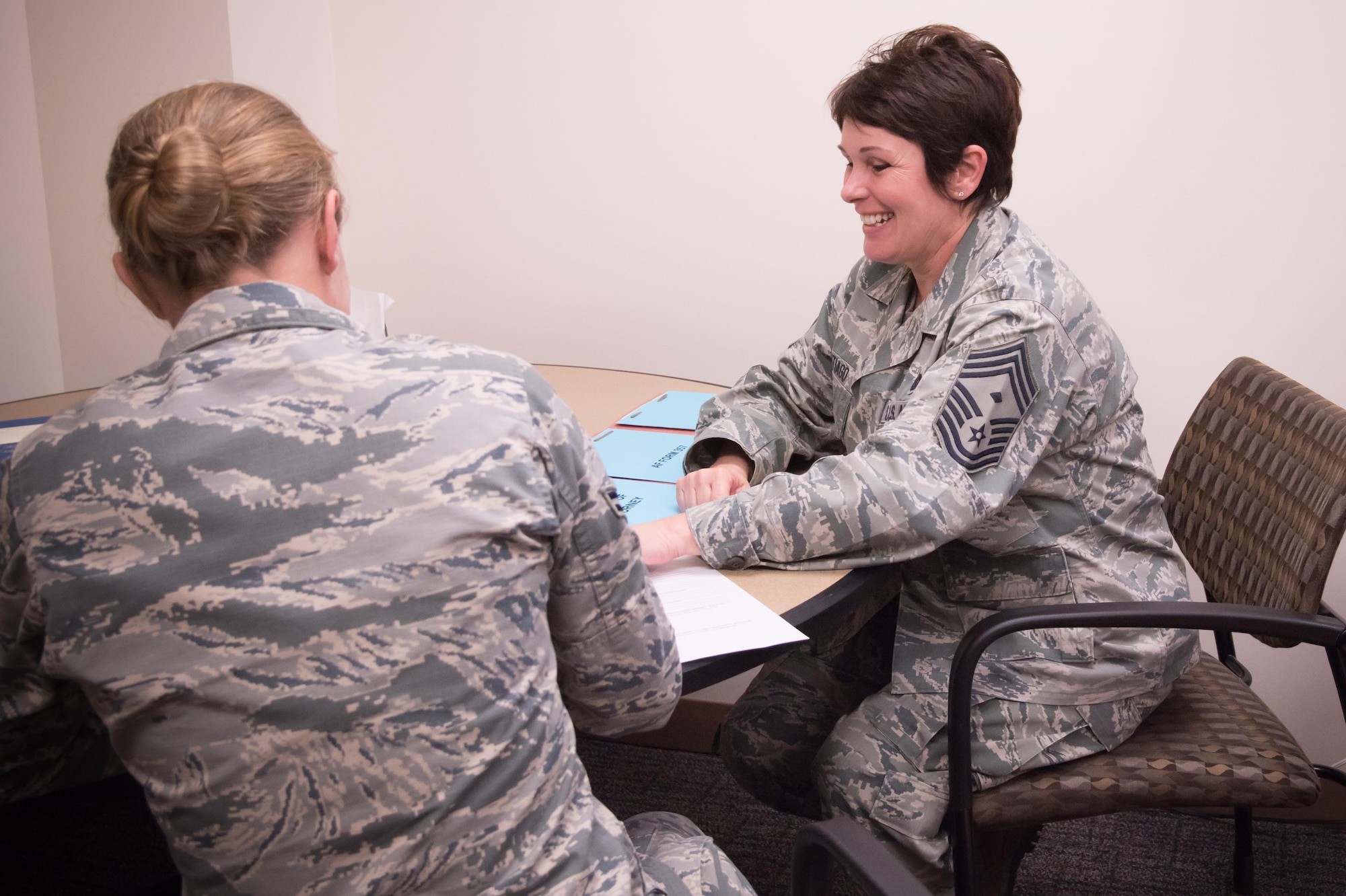 Chief Master Sgt. Michelle Santiago, 403rd Maintenance Squadron first sergeant, helps Airman 1st Class Jennifer Whittington, 403rd MXS aircraft maintainer, fill out paperwork Feb. 12 at Keesler Air Force Base, Mississippi. (U.S. Air Force photo/Staff Sgt. Heather Heiney)